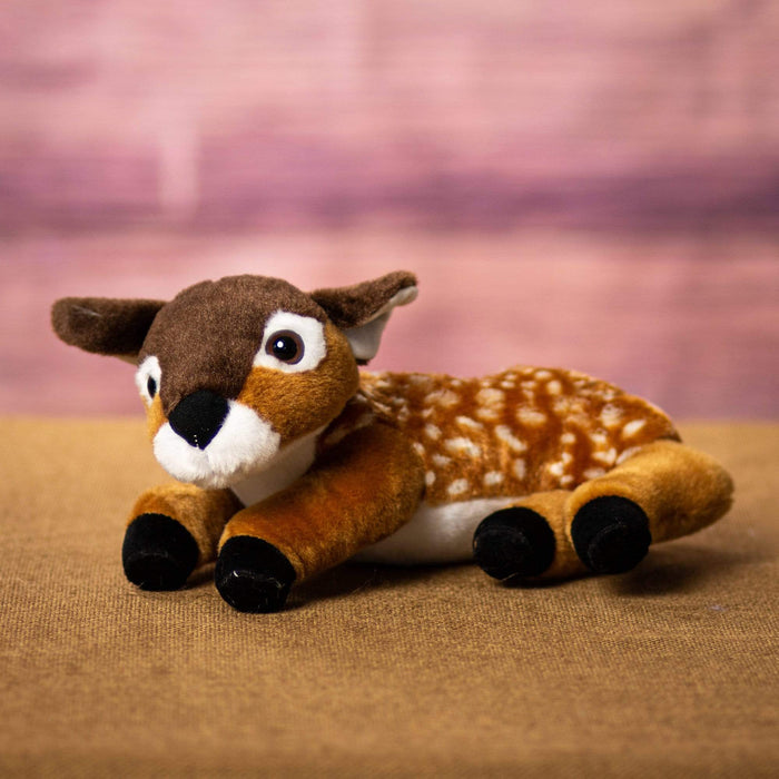 A laying down fawn that is 10 inch from head to tail