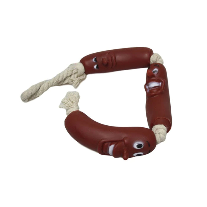 Three brown sausage-shaped toys with playful faces connected by a cream-colored rope.