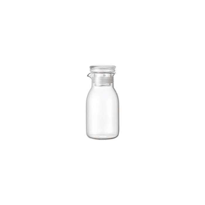 Clear glass bottle with a silver lid on a white background
