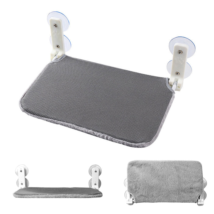 Gray cordless folding cat window hammock with suction cup attachments and a soft, textured surface.
