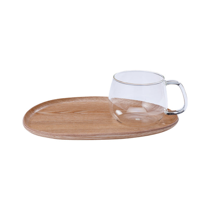 Clear glass mug with wooden tray on a white background
