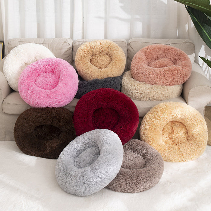 A colorful assortment of plush round pet beds in various shades, displaying a cozy texture on a couch.