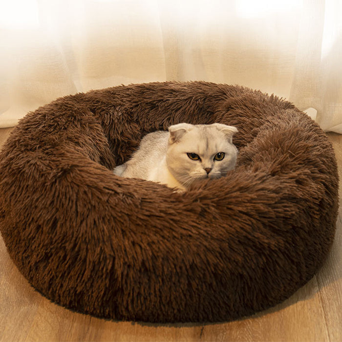 Soft brown plush round pet bed with a cozy interior, featuring a cat comfortably lounging inside.