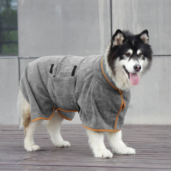 Gray microfiber dog bathrobe with orange trim, featuring pockets, shown on a smiling dog standing on a wooden surface.