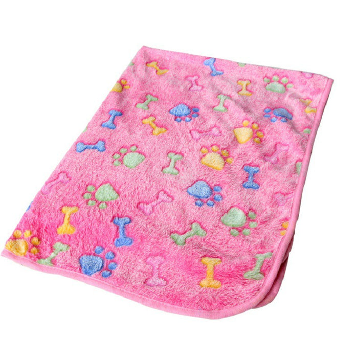 A soft pink pet mat featuring colorful bone and paw print patterns, made from plush material for warmth and comfort.