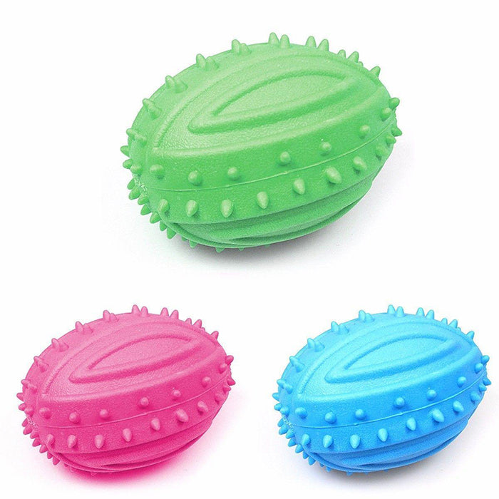 Three squeaky rugby-shaped ball toys for dogs in green, pink, and blue, featuring textured spikes for grip.
